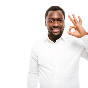 Image of attractive young african man dressed in shirt standing with okay gesture isolated over white background.